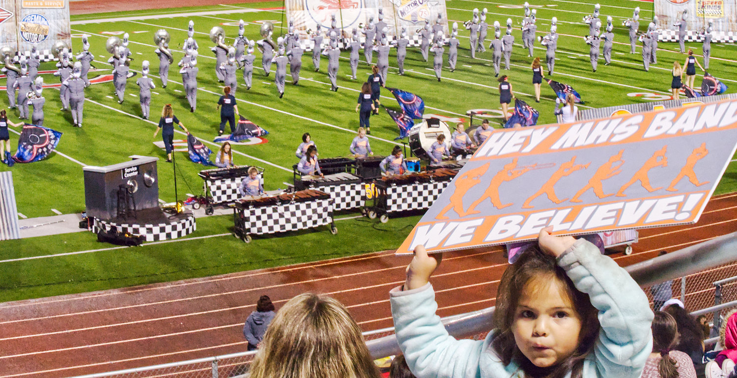 A young fan cheers on the band during their finals performance Saturday evening.